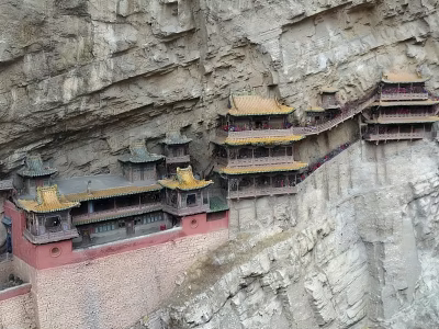 Ancient Architecture on Cliff Featuring Multi Story Structure and Yellow Roofs 3d model