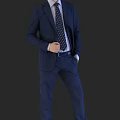 Man in Dark Blue Suit Adjusting Polka Dot Tie with Hand in Pocket