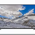 Smart TV Displaying Vivid Snowy Mountains and Blue Sky with White Clouds