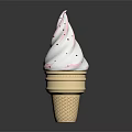 Creamy White Ice Cream In Waffle Cone Topped With Red Sprinkles On Dark Background