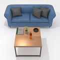 People Relaxing Together on Blue Sofa With Three Gray Pillows and Wooden Coffee Table