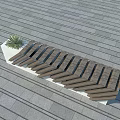 Outdoor Bench With Wooden Herringbone Design And Small Plant On Gray Stone Pavement