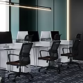 Modern Public Office Space With White Desks Black Chairs Multiple Computers And Natural Light