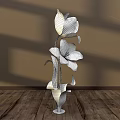 Floral Display with Yellow Tulip and Pink Striped Flower in Green Vase on Wooden Floor