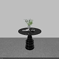 Modern Black Round Dining Table With Spiral Base Green Plant White Cup And Black Decor