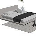 Double Bed with Gray Headboard White Pillows Black Blanket on Gray Rug and Nightstand Plant