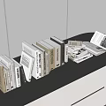 Books and Magazines Display on Black Countertop Neatly Arranged with Open and Stacked Books