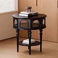 Black Round Top Side Table With Carved Legs And Storage Shelf In Living Room