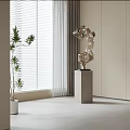 Modern Abstract Decorative Sculpture on Gray Pedestal Near Window with White Blinds Green Plant