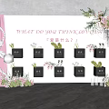 Commercial Display Equipment With Black Square Boxes And Floral Decorations On White Wall
