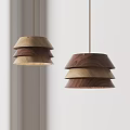 Modern Layered Wooden Pendant Lights With Different Wood Tones Hanging In Minimalist Space