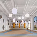 Bright Fitness Training Studio With Yellow Punching Bags Blue Mats And Round Ceiling Lights