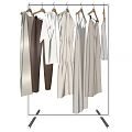 Light Colored Clothes Hanging On Rack Featuring Dresses Tops And Pants