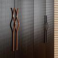 Curved Wooden And Metal Cabinet Handles In Brown Black On Dark Wood Panel