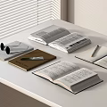 Open Books and Magazines on White Table with Notebook Pen and Sunglasses