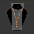 Stylish Beaded Necklace With Orange And White Beads On Black Mannequin