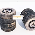 Old Stacked Vehicle Tires With Metal Rims And Worn Tread Patterns