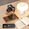 Open Books and Magazines on Wooden Table with Lamp Camera Notebook and Mobile Phone