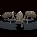 Three Silver Bull Sculptures On Black Circular Platform With Dark Background