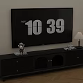 Black TV Stand With Large Screen TV Decorative Items And Table Lamp In Living Room