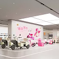 Spacious Bright Electric Vehicle Specialty Store With Pink Decor And Multiple Models