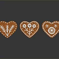 Heart Shaped Gingerbread Cookies Decorated With White Icing And Floral Patterns