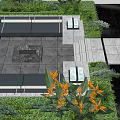 Modern Landscape Seating In Outdoor Garden With Lush Green Plants And Central Fire Pit