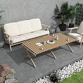 Beige Outdoor Sofa Set With Wooden Coffee Table And Green Plants On Stone Patio
