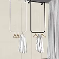 White And Black Hanging Metal Hangers With Minimalist Design Holding White Shirts In Bright Interior