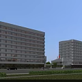 Two Modern Multi Story Office Buildings With Large Windows Road And Green Landscaping
