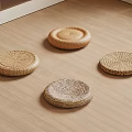 Four Natural Woven Rattan Cushions Arranged On Wooden Floor
