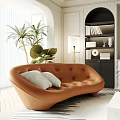 Brown Irregular Shaped Leather Sofa With White Cushions Green Plants Floor Lamp And Bookshelf