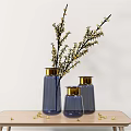 Blue Vases With Gold Rims Holding Yellow Blossom Branches On Wooden Table With Scattered Flowers