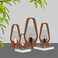 Modern Wooden Frame Table Lamps With Glass Shades In Various Sizes On Gray Tabletop