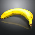 Ripe Yellow Banana With Brown Spots On Shiny Black Background