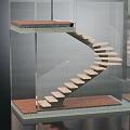 Modern Spiral Staircase With Glass Railing And Light Wood Steps In Interior Space