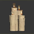 Beige Cylindrical Decorative Candles With Wax Drips On Dark Surface