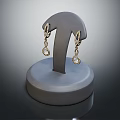 Elegant Gold Diamond Earrings on Gray Round Base Jewelry Display Stand