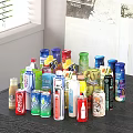 Variety Of Assorted Bottled And Canned Beverages On Kitchen Table