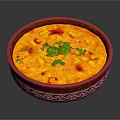 Delicious Yellow Creamy Dish in Red Patterned Bowl with Fresh Green Cilantro and Red Garnish