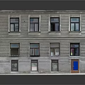 Multi Story Residential Building With Gray Stone Facade Neatly Arranged Windows And Blue Door