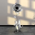 Elegant Floral Display with Orange Yellow Flower Green Leaves and White Pebble Base