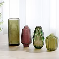 Colorful Textured Vases Arranged On Light Table With Green Plants In Bright Room