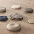 Various Soft Round Fabric Cushions In Different Colors On Wooden Floor