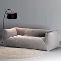 Modern Minimalist Gray Large Sofa With Black Floor Lamp And Light Colored Rug