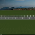 Long Bridge With Gray Road Surface And White Railings Over Green Fields And Mountains