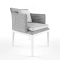 Stylish Wicker Armchair With Black Legs White Cushion And Red Patterned Pillow
