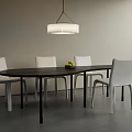 Modern Oval Dining Table Set with Black Tabletop White Chairs Pendant Light and Fruit Bowl