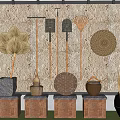 Traditional Industrial Equipment Display with Brooms Rakes Baskets on Wooden Stone Platforms Stone Wall Background