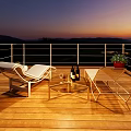 Stunning Sunset Mountain Landscape View From Warm Wooden Terrace With Relaxing Lounge Chairs And Wine